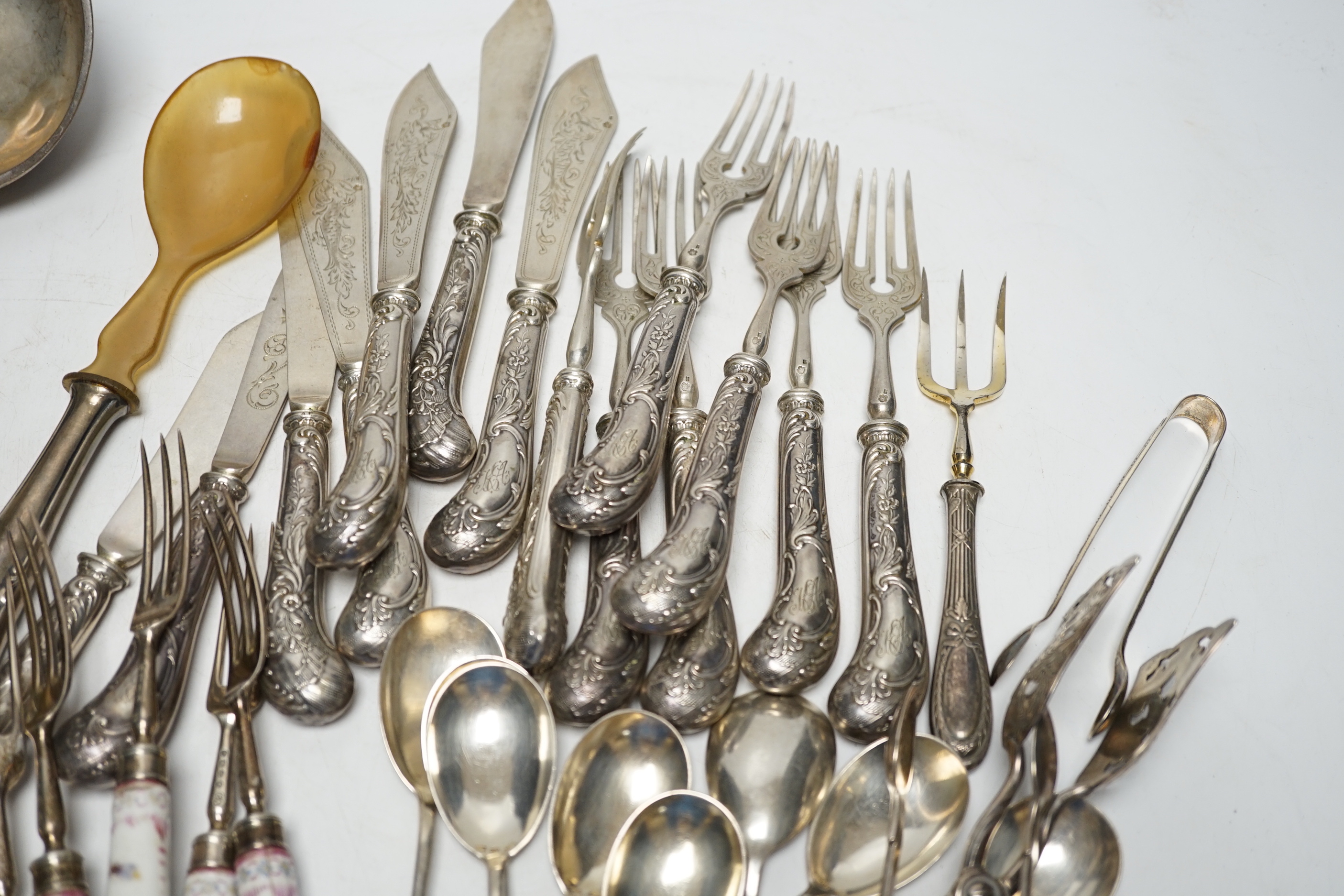 Six Victorian silver dessert forks by George Adams, London, 1880, with Meissen handles, 17.5cm(a.f.), eight 800 standard sorbet spoons, seven pairs of Austro-Hungarian white metal fish eaters, five other continental item